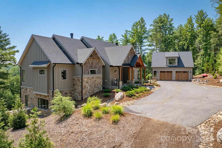 Experience timeless comfort and refined lakefront living in this exceptional 2022 custom home in Old Wildlife Club on Lake James, designed by a Southern Living Designer of the Year. Set on nearly 3 private acres with two adjoining community-owned conservation areas, this retreat offers rare seclusion and panoramic water views from nearly every room. Enjoy ample bedrooms featuring ensuite baths, including a guest suite over the heated/cooled detached garage. The vaulted primary suite features a spa bath with soaking tub and lake views. Thoughtful craftsmanship includes wide-plank hardwoods, 10-foot ceilings, stone fireplaces, shiplap, and natural wood throughout. Entertain easily in the open living spaces, gourmet kitchen, and expansive screened porch. The walkout level includes a large family room and wet bar. Outside, enjoy terraced hardscaping, a lakeside firepit, and a drivable path to the private dock. Membership to Camp Lake James, the area's premier amenity center, is included.