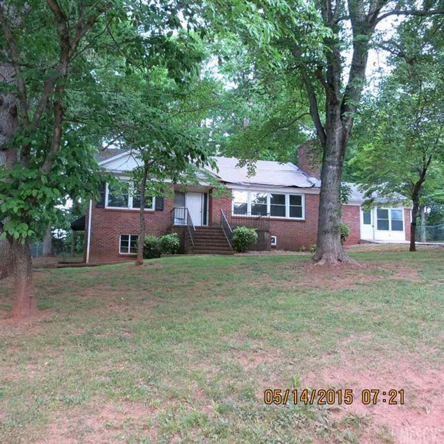 All brick with basement on Conover side street has much potential w/hardwood & tile floors.  3 full baths (one in basement), LR w/FP, Formal DR.  Unsure of basement HVAC.