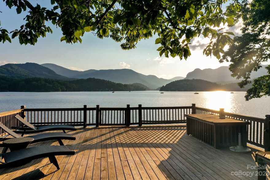 THE BEST VIEWS ON LAKE LURE! This Private Lakefront Estate is situated on 2.58 acres and has over 350 feet frontage on beautiful Lake Lure and includes multiple additional building sites.....all with spectacular mountain and lake views.....the best on the lake! The property also includes a fully furnished and newly remodeled, 4 bedroom, 3 1/2 bath, 2900 sq ft, European style lake home with incredible wrap around, screened porches with massive outdoor stone fireplace. You'll also love the custom two stall boathouse which features multiple decks and easy access into the lake. This custom home, built by Carlson-Farmer General Contractors is truly one of the premier "Private Estates" on Lake Lure! Offered at $2,950,000.