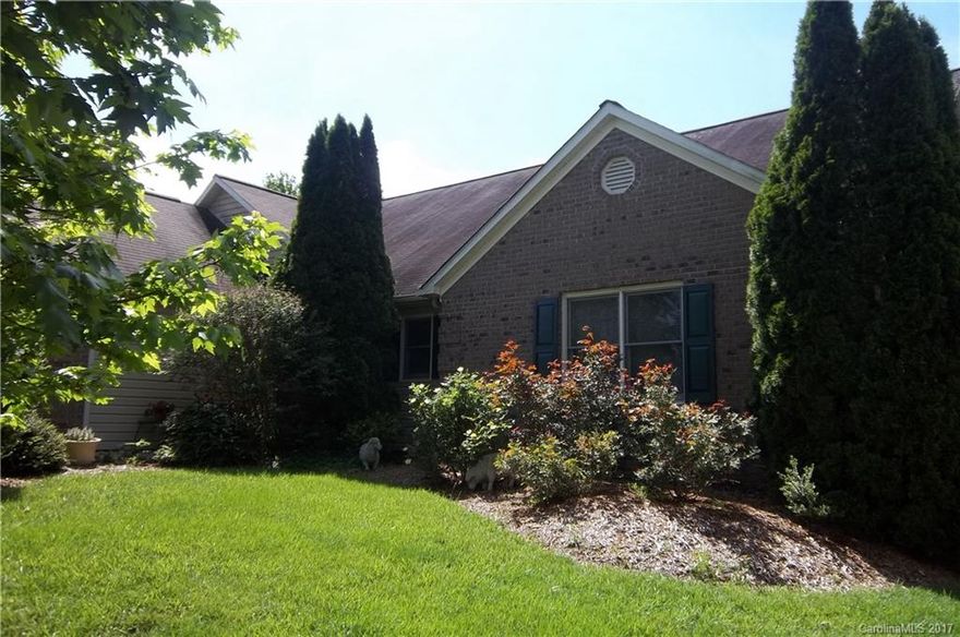 Living room with cathedral ceilings opens into the columned sunroom with tile floor. Garage with built in storage.