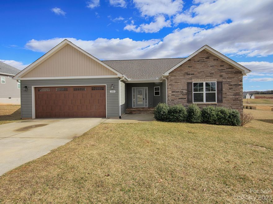 Is this the home you have been waiting for? This amazing ranch greets guests with a stone front, a covered front porch, and a welcoming foyer. Beautiful wide plank hardwoods flow throughout the foyer, bedrooms, great room, kitchen, and dining area. NO carpet! Ceramic tile floors in the laundry and bathrooms. The stunning open-concept kitchen boasts beautiful white and grey granite countertops, ceramic tile backsplash, stainless appliances, a center island, and white custom cabinets. The great room features a vaulted ceiling and a gas-log fireplace. Three spacious bedrooms and two full baths are all on one level. Both bathrooms have granite and two basins. Don't miss the abundant closet space. You will love the covered back porch, a perfect place to relax rain or shine! The oversized 2-car garage provides ample parking plus more storage space. The Castlegate community is a lovely display of ranch homes on large lots, friendly neighbors, a community pool, and low Iredell County taxes.