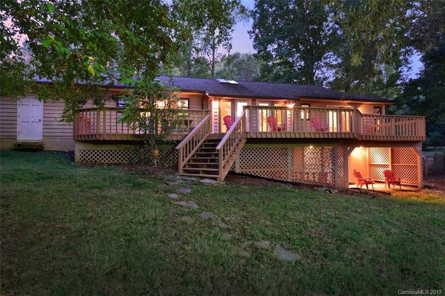 Live on the lake! This well-maintained 2 bedroom plus nice bonus room, 2 bath home has a wonderful open floor plan with cathedral ceilings & fireplace. Huge deck overlooking a flat yard & boathouse. Easy access to the waters edge. Garage & carport. Located in Woodrun! Good water depth!