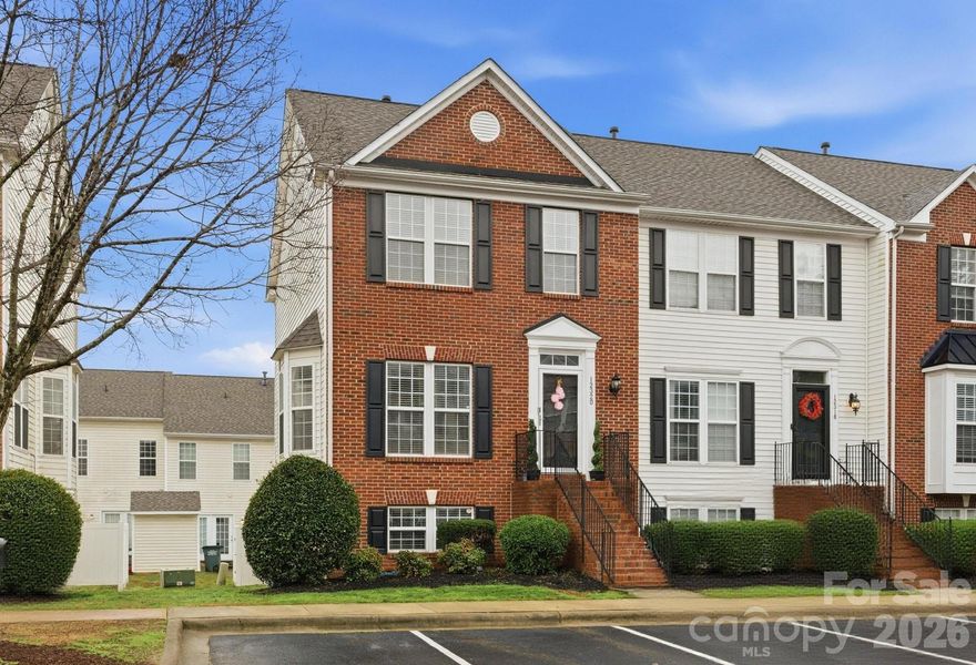 Beautiful brick-front end unit townhome tucked away in the quiet Garden Oaks community! This move-in-ready home is minutes from shopping and dining with easy access to I-485. Recent updates include a 2024 roof and new carpeting in 2025 throughout the upstairs and stairway to the basement. The main level features hardwood floors and an updated kitchen complete with stainless steel refrigerator, microwave, and oven, quartz countertops, tiled backsplash and 42-inch cabinets with updated hardware. Stylish modern accent walls and updated lighting throughout the home add a modern feel. The spacious primary bedroom includes a large custom walk-in closet system. The finished lower level offers a generous den/media room, perfect for entertaining, relaxing, or a home office. French doors lead to a deck freshly stained in 2025, ideal for gatherings, while the lower level also provides a covered patio with basement access and an enclosed fenced area for added privacy. HOA provides exceptional value, covering water, sewer, trash, lawn care, exterior maintenance, and dog waste stations. Don’t miss this beautifully updated end unit—schedule your showing today!