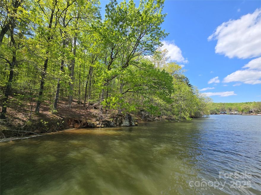 This Badin Lake waterfront property is located in the gated community of Woodland Estates. A rare opportunity to own waterfront acreage: 6.49 acres. 302 feet of waterfrontage. Tax value: $316,360. Previous septic approval for a 3 bedroom home. 2017 survey on file. Woodland Estates is surrounded by the Uwharrie National Forest: a true paradise for outdoor enthusiasts. Enjoy boating, hiking, camping, and fishing. Also horseback riding and ATV/OHV trails. Horses are allowed in Woodland Estates. The neighborhood offers all paved roads, playground, and a paved boat ramp with pier. Agents must accompany buyers the entire time while inside the neighborhood. Convenient to the lake’s marinas that provide dining, gas & watercraft rentals. Within 1 hour from Charlotte, Greensboro, or Winston-Salem. Call Listing Office for additional information, or to schedule a showing.