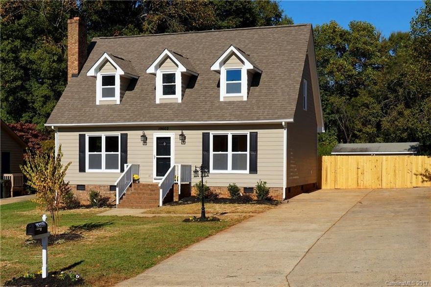 FULLY UPDATED & MOVE IN READY- 3 BR/ 2 BA home on an enormous, private, fenced lot of over 1/2 acre within walking distance of Antiquity and downtown Cornelius. All new vinyl windows. Laminate wood and tile flooring throughout 1st floor. Stainless appliances, refinished cabinets, and granite with mosaic backsplash in updated kitchen. New carpet and tile upstairs & fresh paint throughout. Large double driveway w/ room to add a garage, almost 400sf workshop/ shed and 12x20 deck for entertaining.