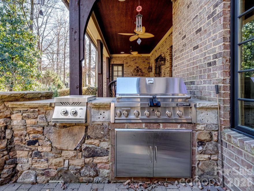 Welcome to this masterfully designed Frank Smith home that blends timeless architecture with exceptional modern luxury. Thoughtfully crafted for both elegant entertaining and everyday comfort, this residence showcases refined finishes, impeccable attention to detail, and versatile living spaces throughout.
At the heart of the home is a gourmet kitchen, designed for the serious cook, complemented by a fully equipped scullery —perfect for hosting, catering, or seamless organization. Showcase your collection in the impressive 900 bottle, climate controlled wine room! The adjacent great room offers an inviting gathering space filled with natural light and effortless flow. The main-level primary suite is a private retreat, featuring a spa-like bath with heated tile floors, luxurious fixtures, and a calming, resort-style ambiance. Additional main-level conveniences include a beautifully appointed study, a laundry room with custom cabinetry, and a thoughtfully designed kids’ study/craft room. Entertain with ease in the media room, stay active in the exercise room. A whole-house generator provides peace of mind year-round. The detached garage includes a finished room above, ideal for guest quarters, a private office, or second living space. Outdoors, the professionally landscaped yard creates a serene setting for relaxation and entertaining, completing this exceptional property. 229 Wrenwood Lane offers a rare combination of architectural pedigree, luxury amenities, and functional design—an extraordinary place to call home.