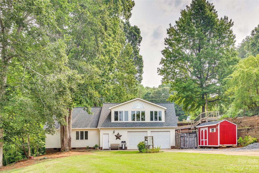 Found on Lake Wylie's eastern shore, here is an opportunity to buy an existing three bedroom home and lot large enough to build an even larger new lake home next to it with no HOA. Lots of natural light in the open living area and kitchen which boasts granite counters, breakfast bar, and stainless steel appliances. Two bedrooms and full bathroom up and primary bedroom and bathroom on lower level. Easy access to Charlotte Douglas International Airport, Uptown, Whitewater Center, and commuting routes. Close to Charlotte's new planned community The River District!