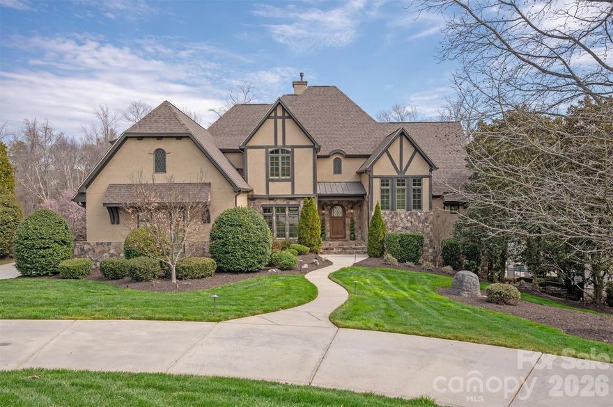 WOW!  This custom estate has been meticulously maintained and thoughtfully updated in the gated community of Providence Downs South.  A rare five-car garage sets the tone for the scale and sophistication found throughout.  The chef's kitchen is appointed with a Sub-Zero refrigerator, premium Wolf ovens, dual islands, and an open-concept layout that flows seamlessly into the expansive family room that overlooks heavily wooded backyard.  The primary suite is conveniently located on the main level, creating a private retreat, while each secondary bedroom upstairs features its own en-suite bath for ultimate privacy.  The finished walkout basement is designed for luxurious living and entertaining, complete with a second primary suite, state-of-the-art theater room, and a secondary kitchen - perfect for guests or multi-generational living.  Outdoors, enjoy resort-style amenities including a spacious main-level terrace, sparkling in-ground pool, firepit lounge area, and multiple outdoor living spaces designed for year-round enjoyment in a super private backyard.  The upgrades are endless with Control 4, foam insulation, private well for irrigation....the list goes on.  Located within the highly sought-after Marvin Ridge High School district.