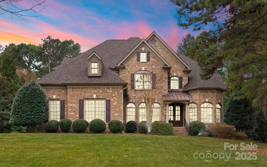 MULTIPLE OFFERS RECEIVED. PLEASE SUBMIT HIGHESt/ BEST BY SUN FEB 23 AT 7PM.Stunning Custom Brick Home in a gated Weddington community is Move-In Ready! Nestled on a private nearly one-acre cul-de-sac lot, this immaculate 4-bedroom, 4-bath home has it all! A desirable guest room & full bath on the main floor, as well as office & formal dining room. The Elegant Great Room has Coffered ceilings, custom built-in bookshelves, and an inviting open layout with views of the expansive backyard.  The Gourmet Kitchen boasts an Oversized island w/breakfast bar, custom cabinetry, granite counters, 6-burner gas range + second wall oven.
The Luxurious Owner’s Retreat has Sitting area w/ gas fireplace, spa-like bath w/double vanity, soaking tub, shower and spacious walk-in closet.  2 additional beds+ a Bonus Room (or 5th Bedroom) up.. New retractable awning keeps you shaded in the Private Backyard Oasis w/ patio, perfect for entertaining! The community has a scenic pond. Top-rated Weddington schools!