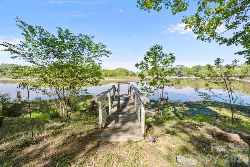 Build your dream WATERFRONT life in this cul de sac lot surrounded by water on two sides. On Crowders Creek that feeds into Lake Wylie. Currently accommodates shallow water activities with future plans to dredge for deeper water, making this a great time to invest. Super convenient location - less than 5 minutes to shopping, restaurants and highways but surrounded by nature at it's best. Enjoy the tranquility of waterfront living, the scenic views of Lake Wylie along with all the Lake Wylie community offers. While the original structure has been lost to a fire, the land remains, with the original foundation still in place, providing a head start for potential buyers.  There is already a dock in place that will need some upfitting.  Community well and septic service this lot. Top Rated schools.