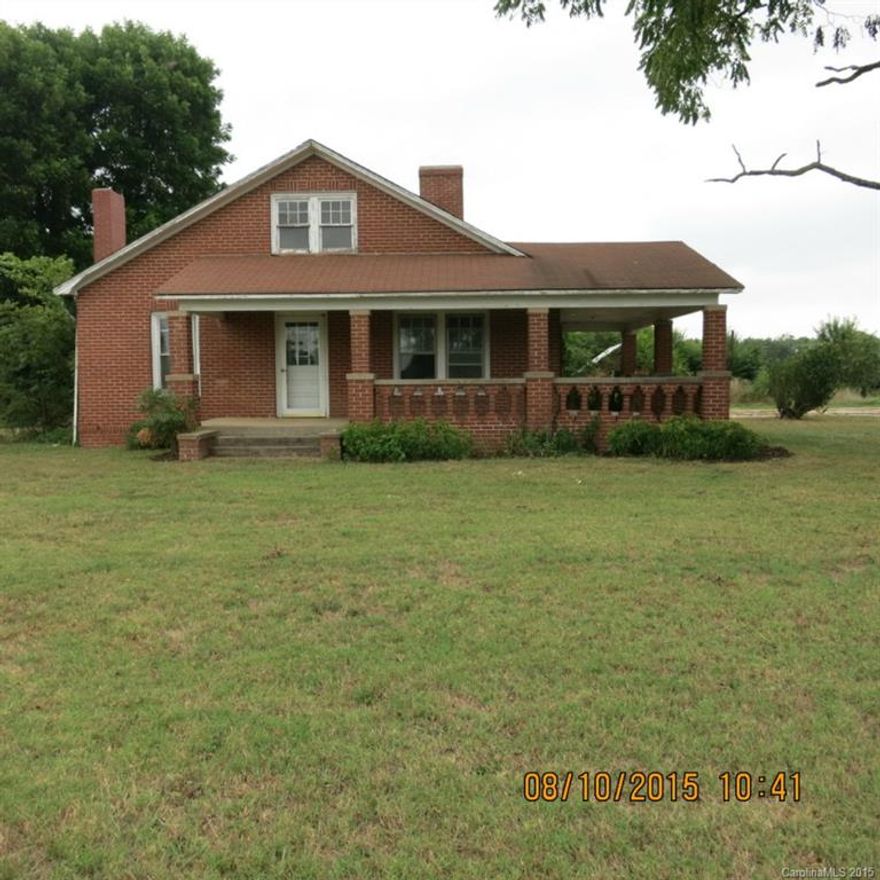 Brick 1 1/2 story on 1.98 acres features LR w/ FP and woodstove, 2 bedrooms, 2 baths on main level, with an addition or laundry/game room/exercise room.  Front wrap around masonry porch and side deck.  Great potential for large garden .  2 rooms upstairs could be BR's, but low ceiling.