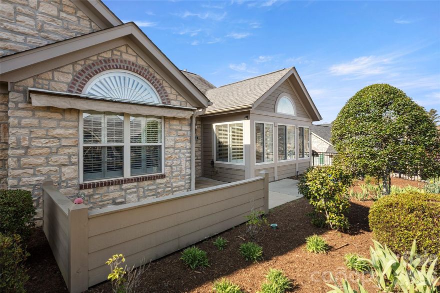 Enjoy easy, low-maintenance living in this beautifully maintained two-bedroom, two-bath home in the desirable Orchards of Flat Rock community. The thoughtfully designed layout offers a seamless flow, ideal for everyday comfort and entertaining. The kitchen opens to a bright living area featuring vaulted ceilings, a cozy fireplace, and custom plantation shutters for added style and charm. A light-filled sunroom provides a relaxing space to unwind year-round, while a private office or study with French doors is ideal for remote work or quiet time. The spacious primary suite includes a walk-in closet and en-suite bath. A second bedroom and full bath offer flexibility for guests. A two-car garage adds convenience, and community amenities include a clubhouse, fitness center, pool and social activities, all just minutes from shopping, dining and downtown Hendersonville.