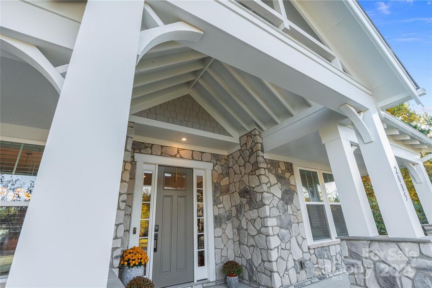 Welcome home to Paddlers Cove in Lake Wylie — where charm meets modern luxury. This residence features one of the largest and most luxurious floor plans in the community, built by Fielding Homes with every available upgrade, then enhanced with additional premium finishes and thoughtful design. From the chef’s kitchen with custom cabinetry, abundant storage, and an oversized island, to the Butler’s pantry with wood shelving, and the open living area with a gas-tiled fireplace — every space was created for connection and comfort. Upstairs, the expansive media and living spaces offer both excitement and retreat, while the extended covered porch invites evenings by the fire and effortless entertaining. With five bedrooms, custom built-in closets in every room, and a 2-car garage that accommodates three vehicles with epoxy flooring and organized storage, this home defines effortless elegance and Southern living at its finest.