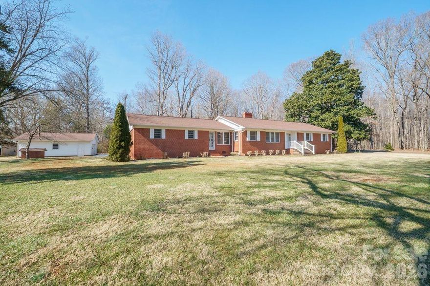 Nestled on 2.06 acre lot in a desirable country setting. This charming brick ranch with unfinished basement has 3 bedrooms, 2 baths on the main floor. Main floor features over 2000 sq ft with a very inviting living room, a variety of uses for the office area, large dining area and wonderful sun room. Per seller updates include architectural roof in 2017, 3.5 ton heat pump in 2020, water heater in 2020, septic pumped in 2016 and new stove in the kitchen. Basement is divided into separate rooms and can be accessed from the outside or inside of home. Basement does not have a separate heating system but has vents in the duct work in 3 rooms to allow for heat. Buyer to verify if the current heating system will handle the area. Attached 2 car garage and detached 720 sq ft wired 1 car garage with wood stove. Perfect for a work shop. Private back yard area with pecan trees. Seller's report that they have never used the fireplaces in living room or basement and are not aware of their current condition. Buyer to verify usability. Buyer to verify school districts. Per Rowan Cty the original septic tank permit is not available.