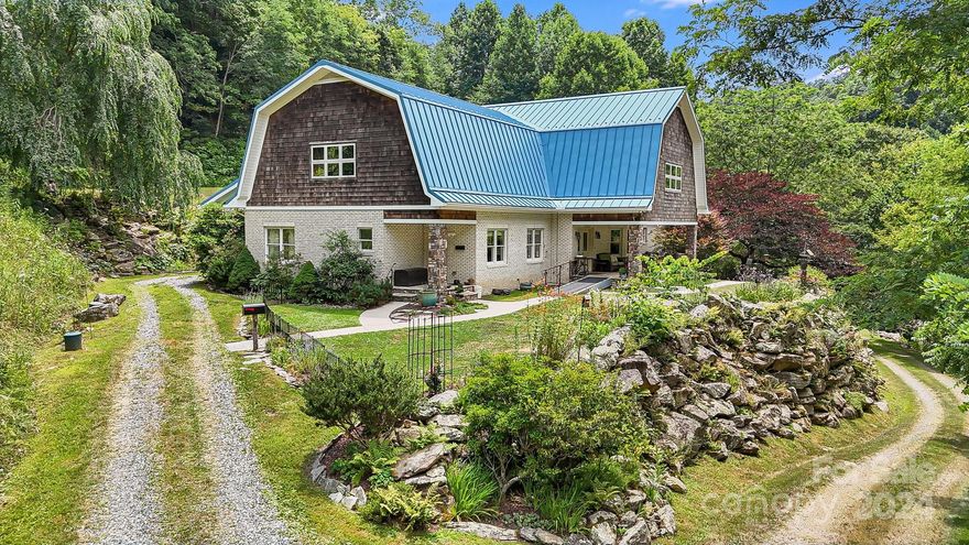 On the market for the first time! Meticulous Dutch Colonial style home, bold creek, large barn, pond, trails, green spaces, and gardens on 36+ acres. Hike on your own property! Manicured trails are in place that meander alongside the creek and to the pond. 4 bedrooms and 6.5 bathrooms. Incredible home office space! Bring your business! High speed internet. All bedrooms are on the main floor with en suite bath. Sunroom and access to outdoor patio from primary Master suite. Radiant floor heat and central air. On the upper level there is a vast workspace/hobby room, a bonus space with a full bathroom, and a storage room.  Would make an incredible studio or home business space! Expansive workshop on lower level along with full bathroom, and 2-car garage. Large barn features a sealed and insulated upstairs and plenty of room to store equipment on the ground level.  Established gardens and mature landscaping throughout. Easy access to Max Patch, Hot Springs, Waynesville, Asheville!