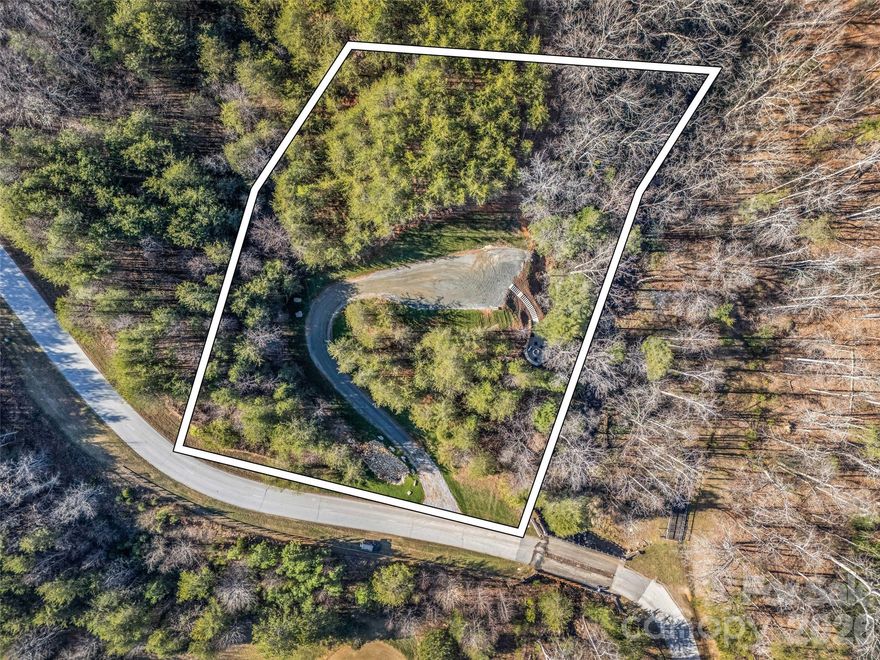 Nestled within the prestigious Bright’s Creek community, this 1.29 acre lot has been cleared & the homesite prepared to begin construction quickly. This offers a rare opportunity to build your dream home amidst the tranquil beauty of Western North Carolina.The driveway has been installed leading to your private homesite where you will find a beautifully designed hardscape with firepit & seating area overlooking the gently flowing Bright’s Creek. This picturesque parcel boasts stunning natural surroundings and serene ambiance that invites relaxation and rejuvenation.The Brights Creek community is renowned for its luxury amenities and vibrant community atmosphere. Club members enjoy access to a world-class Fazio designed golf course, equestrian facility, trails, tennis/pickleball allowing for a lifestyle of leisure and recreation. If you are looking to save months of planning and are ready to begin construction make an appointment to see this opportunity today.Seller financing available.