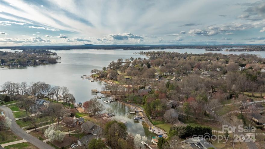 Immediately fall in love with this meticulously upgraded WATERFRONT home on a .61 acre cul-de-sac lot w/135' of shoreline on Lake Norman. From your private dock/pier gazebo with beautiful sunset views to the incredible amount of upgrades: NEW....Roof, Upstairs HVAC, Water Heater, Siding, Gutters, Windows, Inside & Outside Doors, Dbl driveway w/a 3rd drwy, Add'l gravel side pkg space for an RV/trailers/toys, Upper Deck w/ Electrical, Lake-fed Irrigation & pump, Landscaping & lighting, Hdwd Flooring, Carpet, LVP, Paint, Lighting,Sinks/Faucets/Toilets. Bright open floorplan with high ceilings & water views in the Living Room, Remodeled Kitchen, Dining Room, Breakfast Area, and vaulted Great Room w/gas log fireplace.Oversized Primary Suite upstairs w/ remodeled Ensuite Bath, and 2 secondary Bdrms w/a newly remodeled bath. Garage level features another bedroom/office, laundry room & 1/2 ba. Over 700 sq ft of HEATED walk out basement area-perfect for any needed flex space.