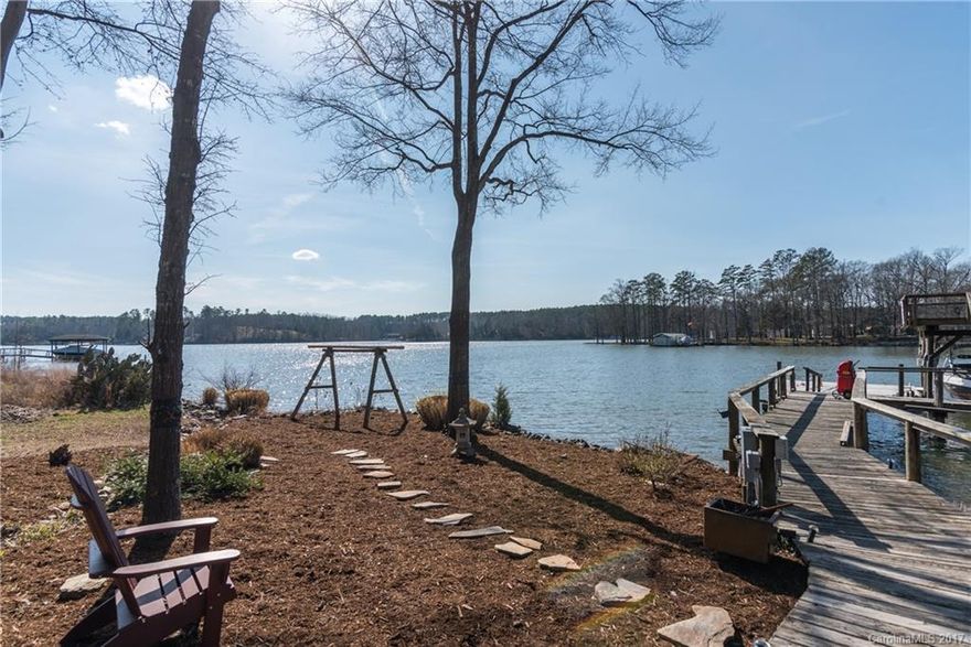 This rustic, open floor plan home has 138' of shoreline, boat slip w/ new lift and dock with 2 drive up ramps for wave runners w/observation deck.  The kitchen has new cabinetry, new stainless steel appliances w/appliance garage, 4 pantries, granite counters, vaulted ceilings; they extend into the Great Room w/ Dining Area.  Large Laundry Room. This level, beautifully landscaped waterfront property has outdoor kitchen, gazebo, greenhouse, storage building, 300 sq. ft covered rear deck.  No HOA.