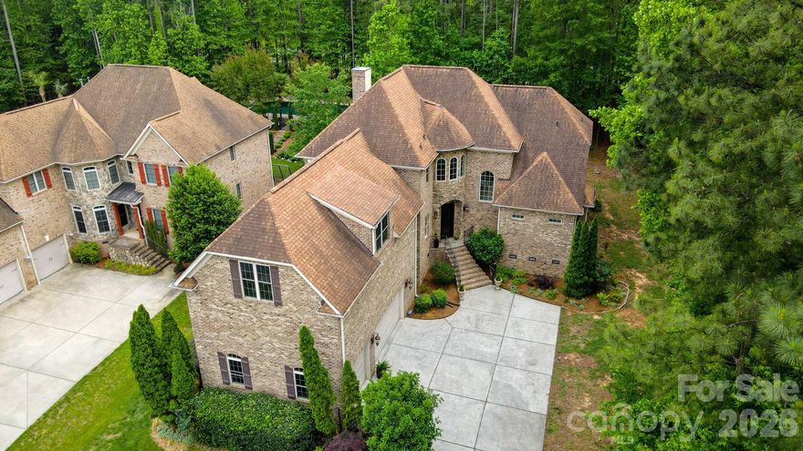 Custom Craftsmanship Meets Lakeside Lifestyle Where Timeless Elegance Meets Modern Shoreline Living
Prepare to fall in love with a home that defines presence.  Located in the highly sought-after Palm Tree Cove, 275 Palm Cove Way is a stunning full-brick and stone custom estate that balances grand architecture with the warmth of a true family sanctuary.  Situated just moments from the shores of Lake Wylie, this 3959-square-foot masterpiece offers a lifestyle of quiet luxury and community convenience.  
Make a lasting first impression with the grand entry foyer that leads into a soaring two-story great room with cathedral ceiling, cozy gas fireplace, and French doors that open to a back deck for relaxation and solitude.  Bathed in natural light from a wall of windows, the living space features rich hardwoods that have recently been refinished, intricate exquisite crown moldings can be found throughout the home on ceilings and floors in every room, UV protected and black out Roman blinds, ensuring your home stays cool and your finishes stay pristine.  
Luxury is standard here, with a main-level primary suite featuring tray ceilings, panoramic bow windows, an exit door to the back deck, a garden tub with cathedral tray ceiling, massive walk-in shower and oversized walk-in closet space.  Upstairs, the layout is a dream for family or guests; each of the large bedrooms includes its own private full bath and a walk-in closet, offering a level of privacy rarely found in today’s market.  The kitchen is a chef’s delight with high end finishes, a massive island, custom cabinets, a walk-in pantry, stainless steel appliances and plenty of counter space for that holiday party or family gathering.  They say the kitchen is the heart of the home, and this one is no exception!  With an open floor plan, you can enjoy the guests mingling in the great room, while still keeping watch over your menu!  And if that’s not enough, there is also a formal dining room for those extra special occasions you want to remember.
This home comes equipped with a state-of-the-art security system securing all entry points and windows with 360-degree camera footage, as well as an irrigation system in the front and side yard.  The mature natural, sustainable, organic landscaping provides solitude and privacy that cannot be found in many new construction homes today, and includes: fig bush, rocks, trees, grass and evergreen ground cover. The tall, dry crawlspace allows for easy access to underneath the house, and there is over 1,200 sq-ft of storage space available in the attic with walk-in access doors to the attic from the bonus room.  
For the hobbyist or the adventurer, this home is unparalleled.  The oversized, tall 3-car garage is perfect for larger vehicles, while the community offers secure dedicated storage for boats, RV’s and jet skis.  Allison Park is just seconds down the road with public lake swimming, fishing piers, boat access (4 ramps), public soccer, football and pickleball fields.  After a day on the water, unwind on your low-maintenance Trex deck overlooking a private wooded backyard that is already perfectly sized for a future pool.  Enjoy the community pool, complete with picnic and recreational areas, and walking trails for the whole family.   Located in the award-winning Clover School District (including the new Lake Wylie High School), you have the best of both worlds; top-tier education and the benefit of low South Carolina property taxes.  Just a short commute to Charlotte Douglas International Airport and Downtown Charlotte, quaint restaurants and every day shopping.  
From the central vacuum system to the brand-new 2025 hot water heater and new windows, no detail has been overlooked.  275 Palm Cove Way isn’t just a move – it’s an ARRIVAL! Whether you are a lake enthusiast or a lover of fine craftsmanship, this home is the rare find you’ve been waiting for.  Come see the view for yourself and call it HOME!