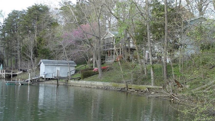 BACK ON THE MARKET!!! Almost $100,000 BELOW tax value! This is a STEAL for someone! Have you always wanted to live on the lake, but couldn't afford the extreme prices?  Now's your chance to make your dream come true!  This property needs attention so it's priced accordingly - WELL below tax value!  With some time & effort, you can have a beautiful lakefront property located in Snug Harbor in the upscale Palisades community.  Don't miss this golden opportunity!  Great location!  Great potential!