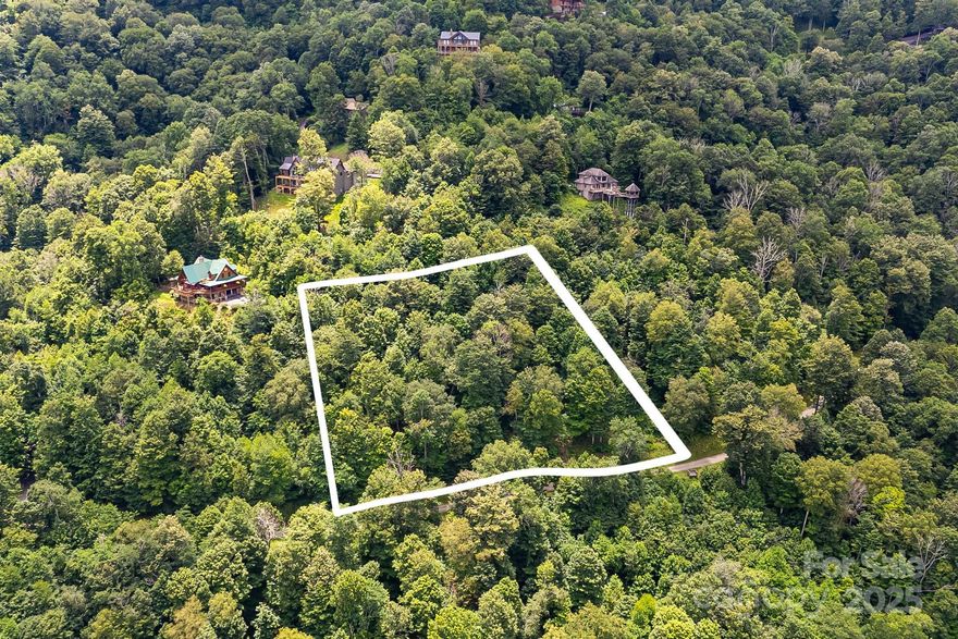 Build your mountain sanctuary on Lot #17 in The Preserve at Wolf Laurel. At nearly 4,000 feet this -acre homesite offers cool summer temperatures and panoramic views of the Bald Mountains. The gated Preserve is bordered by conservation land with miles of hiking and ATV trails and offers quick access to the Appalachian Trail and ski slopes. Residents may join Wolf Laurel Country Club, an 18-hole course rising from 3,600 to nearly 4,800 feet—one of the highest east of the Mississippi—and enjoy fine dining & a friendly atmosphere. The club features a 24/7 fitness center w/strength & cardio equipment, group classes and a yoga pavilion. Optional Village Club membership adds a heated pool, tennis, pickleball, multi-sport courts, trout pond and playgrounds. Social events foster friendships. Burnsville is about 20 minutes away and Asheville roughly 45 minutes. Build your dream retreat in this special mountain community.