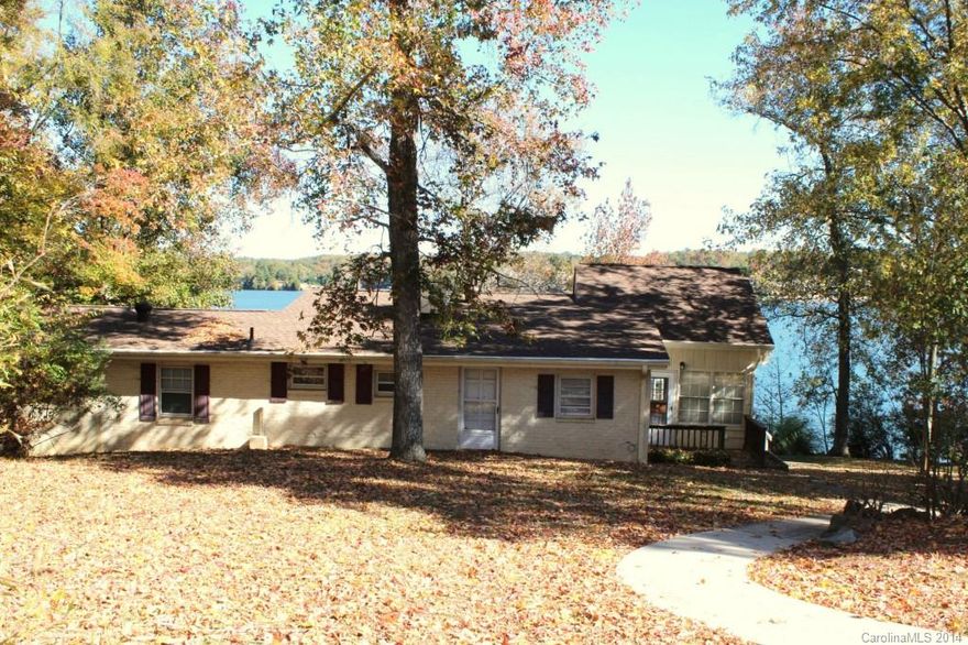 This Lake Wylie waterfront river cabin has been enjoyed by the same family for generations. Perfect for a weekend getaway or your waterfront homestead, it's all about enjoying the lake! Deep water with approx 250' of water frontage on the main channel with sprawling views, a covered boat slip, and dock. Partial basement w/ kitchen area for cleaning the fish. Spectacular sunroom to enjoy the views.