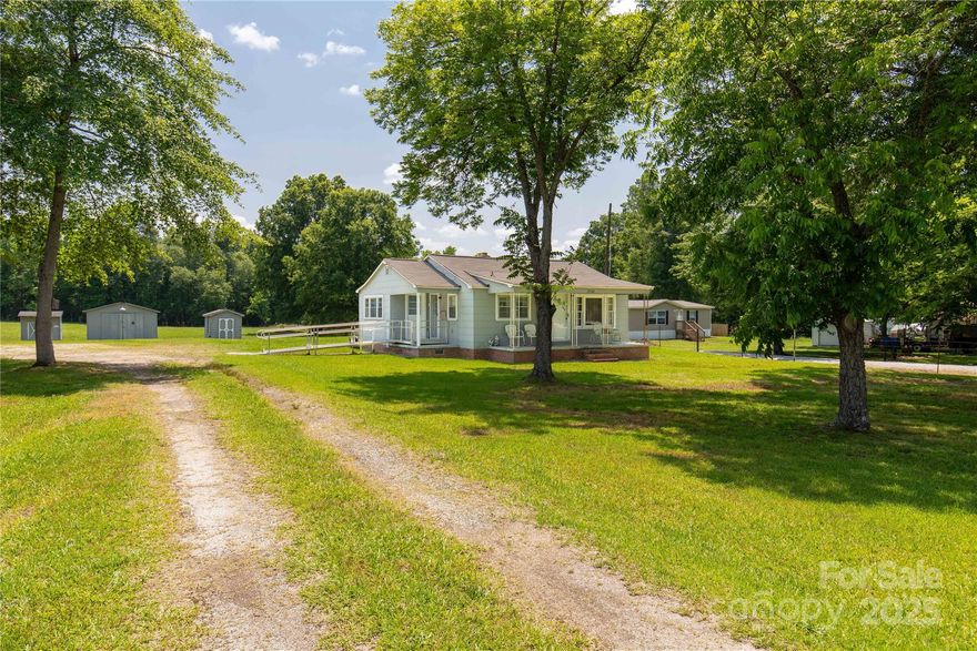 Welcome to the country, just outside the city, older home, offers 2 bedrooms and another room that can be used as a 3rd bedroom, kitchen includes all appliances, hardwood floors under carpet, laundry that includes washer & dryer. All sitting on 3.33 acres, come live in this one and build your dream home in the back to allow lots of privacy.  The buildings are included, along with a 3 vehicle carport. Back section is partially fenced in, so bring your horses. This home has so much potential, just look at what it could be and make it happen. Home is sold AS IS, no warranties on appliances or condition of the buildings.