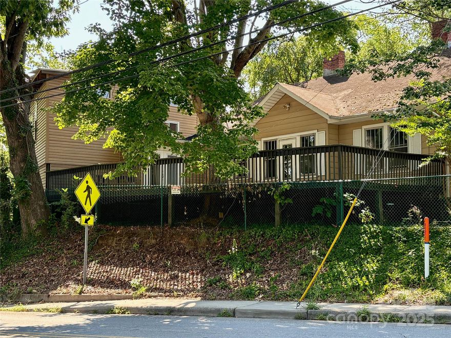 Classic 1920's house with incredible primary suite addition, enormous deck overlooking street below- perfect for entertaining, carport, 3 bedrooms, 2 baths, dining room, finished back entry, heat pump, hardwood & laminate floors, covered front porch, shared driveway,  separate easement for potential ingress/egress, handy West Asheville location, minutes to Downtown, River Arts District and Haywood Rd, property being sold AS-IS,  Be sure to note the Special Location of Lockbox