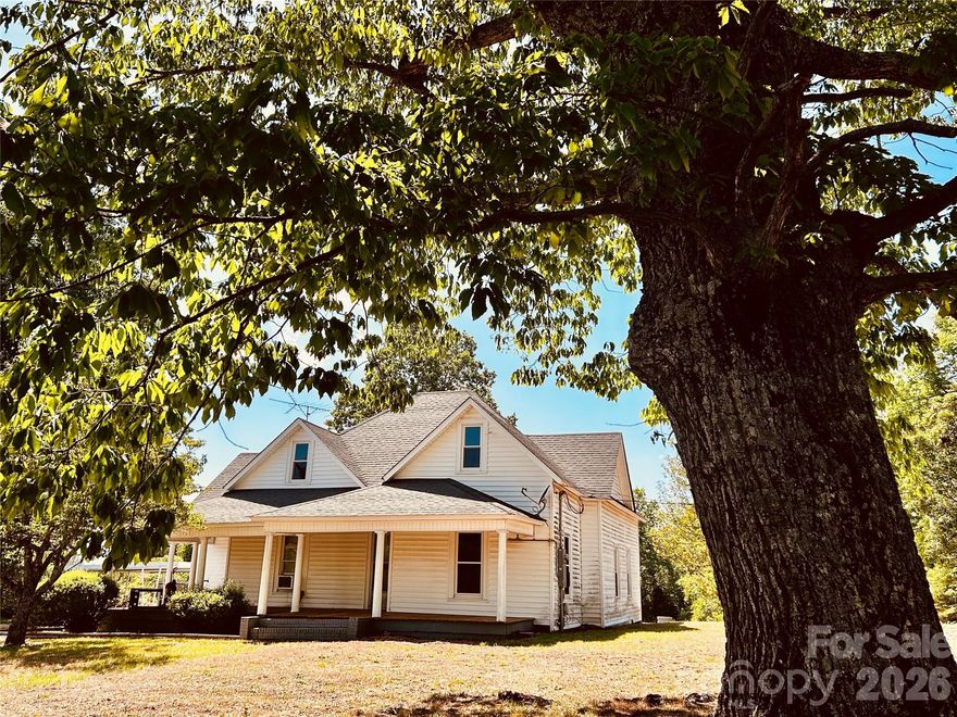 Picturesque setting nestled in mature trees.   Fabulous wrap around porch catches wonderful breezes and overlooks the large front yard and the pastoral view across the road.  Several massive trees anchor this gorgeous setting on 1.37 acres.  Enter into the Living Room.   To the right is a room used as a third BR, but it does not have a closet - would make great office.  Kitchen is at back of the house overlooking tranquil field and woods beyond the home's back yard.  The primary bedroom has an adjoining room that would be great for extra closet expansion, sitting area, study, or for the future addition of a private bath. So much charm and history in great location. Fireplaces in home have been sealed off. 
      ****This is an older home and the owner is selling the home as is.****
****Tax value is for entire Pin #268802650955.   Only a 1.37 acre parcel with house is included in this MLS listing*****