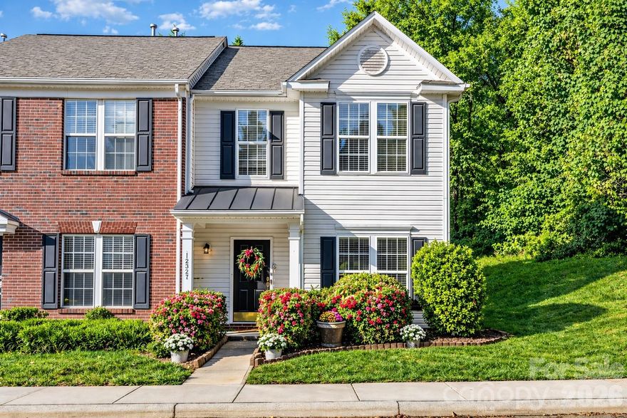 MOVE-IN READY! NEW PRICE! Welcome to this stunning corner-unit townhome tucked at the end of a peaceful cul-de-sac! Surrounded by lush landscaping, this home greets you with pristine white vinyl siding that has just been professionally pressure-washed for a crisp, inviting look. The private patio offers the perfect setting for morning coffee, weekend entertaining, or bird-watching in your tranquil retreat. Beyond the privacy fence, a beautifully maintained common area opens to a tree-lined view—providing extra peace and space rarely found in townhome living. Inside, every inch of this home has been lovingly curated and thoughtfully improved. Enjoy brand-new luxury vinyl plank flooring throughout the main level and both upstairs bathrooms, paired with new plush carpet featuring premium rebound padding underfoot for a soft, comfortable feel. The entire interior has been freshly painted from ceiling to baseboards in neutral designer tones, ready for your personal style and décor. The kitchen has been elevated with refinished cabinetry in a sophisticated hue called Okra, highlighted by burnished bronze hardware that beautifully contrasts against the countertops. Lighting throughout the home was chosen with care, featuring updated fixtures that enhance each space. The true showstopper is the Arteriors “Ramirez” brass and glass chandelier—a striking centerpiece in the dining area that adds warmth and modern elegance. Upstairs, the primary suite is spacious and serene with a tray ceiling, generous walk-in closet, and a relaxing en-suite bath complete with dual vanity space and an oversized garden soaking tub—your private at-home spa. Two additional bedrooms offer roomy closets and share a beautifully refreshed full bath. The soaking tub in the primary and the tub in the shared bathroom have been professionally reglazed, giving them a fresh, like-new appearance. This home combines thoughtful design, modern updates, and a private natural setting—creating a rare find that’s both stylish and move-in ready. Located near shopping, dining, and everyday conveniences, this community also features a sparkling pool, beautifully landscaped common areas, and wide streets ideal for evening walks or morning jogs. Schedule your showing today and experience the perfect blend of comfort, charm, and convenience! This could be your next home!