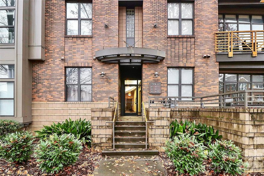 Beautiful city view condo in First Ward area available! This main floor, corner unit,  1 bedroom, 1 bathroom home offers convenient uptown living with lots of storage, natural light, and a dedicated garage parking with elevator and security cameras. Open concept floor plan is great for entertaining! Kitchen features an island, lots of cabinet space plus stainless steel kitchen appliances (oven has microwave option). Bedroom has large closet with plenty of shelving. Large laundry room has extra shelving and stackable washer/dryer.  Small balcony off the living room. Schedule your showing today!