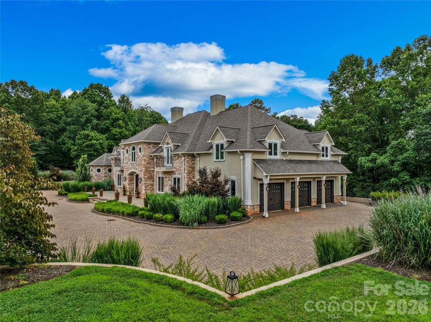 Experience unparalleled luxury, quality craftsmanship, and abundant spaces at this one-of-a-kind property! A stunning brick paver driveway framed by meticulous landscaping welcomes you home. The main level is perfect for entertaining, showcasing a great room with custom library, family room, dining area, and chef’s kitchen with plentiful storage. Ascend via the grand curved staircase or elevator to the upper level, home to the primary suite and additional bedrooms. The primary suite features a private covered balcony, while the opulent bath boasts a steam shower, soaking tub, walk-in closet, wet bar and laundry area. The lower level offers additional finished spaces, including a kitchen, living area, bonus rooms, and full bath. The +-27 acre property offers complete privacy, open spaces, and potential areas to create pastures. All considered, this home offers an exceptional value that is rarely found, perfectly blending top tier construction quality and charm with a spacious floorplan.