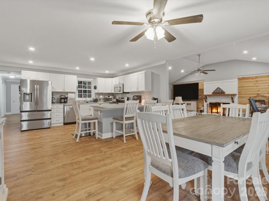Welcome to this stunning, fully refreshed 3 bedroom, 2 bath home nestled in a peaceful countryside setting where modern style meets laid back living in the best way possible!  Step inside and feel the energy of the bright, open concept floor plan designed for today’s lifestyle. The spacious living room, centered around a cozy fireplace, is the perfect spot to gather, entertain, or simply unwind. The seamless flow into the dining area and kitchen makes hosting effortless and everyday living a breeze.  The oversized primary suite is your own private retreat, complete with a spacious en-suite bath built for comfort and relaxation. Two additional bedrooms offer endless flexibility guest space, home office, playroom you decide!  And just wait until you step outside… Enjoy morning coffee on the covered front porch or kick back in the evenings on the covered patio overlooking a fully fenced backyard perfect for pets, play, and entertaining. The fire pit area? Absolute game changer for cozy nights under the stars.  Major upgrades already done for you!  Brand NEW roof (2025). New vapor barrier installed and septic recently pumped! Stylish luxury vinyl plank flooring in key living areas.  This home checks ALL the boxes updated, move-in ready, and set in a serene location you’ll love coming home to. Don’t wait homes like this don’t last!