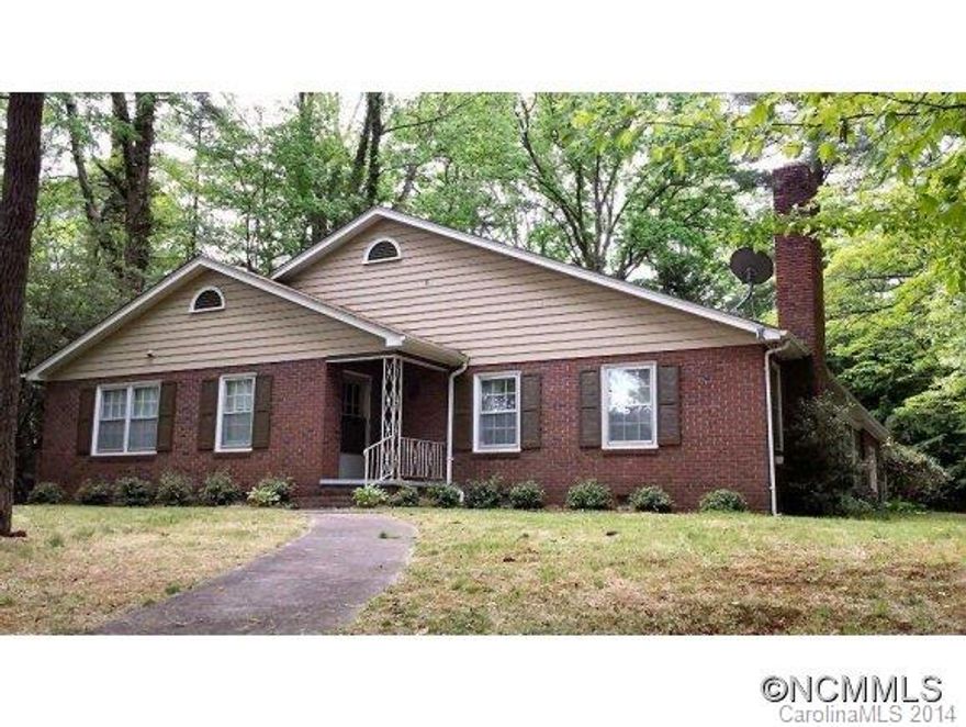 Spacious and gracious brick & frame home on .92 acres of nearly level open and wooded land, in a convenient city location near shopping & medical facilities. Large rooms, most with wood floors. Retro-style kitchen, updated master bath with walk-in shower, wood fireplace in living room. Large center hallway with lots of built-in bookcases. Fully floored attic storage, 1 car garage. Central AC, gas furnace. Nice brick patio, nice landscaping.