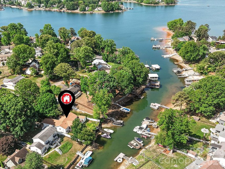 Welcome to your peaceful waterfront retreat with a minimal HOA, tucked away in a quiet cove in the heart of Cornelius, just minutes from the Cain Center for the Arts, shopping, dining, breweries, and parks. A rare and valuable feature, the private pier and dock accommodate two boats, offering easy access to Lake Norman’s main channel and elevating this property into a true lakefront escape. Inside, the bright and airy open floor plan offers a natural flow ideal for everyday living and entertaining. The upgraded kitchen features quartz countertops, a large island with storage, abundant cabinetry, stainless steel appliances including refrigerator, double ovens, five-burner gas cooktop, tile backsplash, and upgraded lighting. The light-filled great room includes a ceiling fan and seamless access to the deck, creating effortless indoor-outdoor living with peaceful lake views. The primary suite provides a private retreat with recessed lighting, ceiling fan, private deck access, walk-in closet, and en-suite bath with dual vanity, tiled shower, and soaking garden tub. Additional highlights include exceptional storage throughout, including a storage shed. Outdoor living is enhanced by an expansive covered deck with step-down access to a large paver patio with fire pit, while the private dock offers open views toward the main channel — perfect for enjoying the Lake Norman lifestyle.