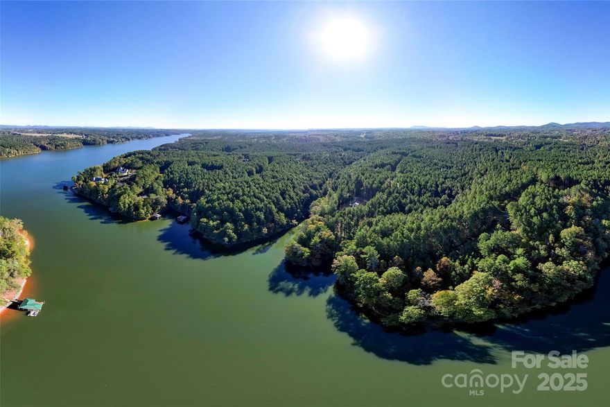 Affordable lakefront living is within reach! This waterfront lot on Lake Rhodhiss is ready for your lake adventures with a stationary Trex dock already in place. Nestled in a quiet cul-de-sac, Lot #266 offers privacy, beautiful hardwoods, and the perfect setting for a basement or walk-out home design. From your private dock, take in views of the main channel while tucked safely in your own peaceful cove.

Located in a gated community with amenities including boat slips, a picnic area, and a lakeside fire pit, this homesite offers the ideal balance of recreation and relaxation. Lake Rhodhiss, part of the scenic Catawba River between Lake James and Lake Hickory, features 93 miles of shoreline and 3,060 acres of crystal-clear water for boating, fishing, and kayaking. With new homes under construction and a minimum build size of just 1,700 sq. ft.,  don’t miss this rare opportunity to own an affordable lakefront lot in the foothills of the Blue Ridge Mountains—your North Carolina lake life starts here!