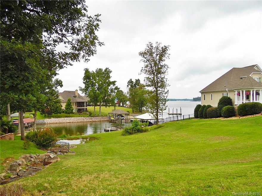 Gorgeous waterfront lot in prestigious Joslin Pointe gated community has the best of both worlds – protected cove plus expansive main channel views!  Amenity-rich neighborhood includes neighborhood pool and cabana, private beach, security gate, and old world gas lanterns throughout.  Lot has a peaceful bubbling rock water feature that is maintained by HOA.  Approved 7000 sq ft home plans available.  Nice dock already in place!  The lake lifestyle you’ve always wanted awaits…