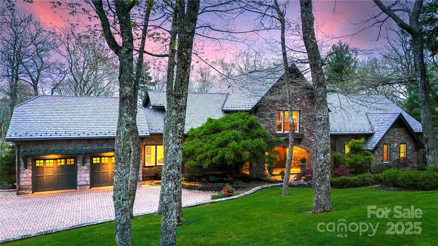 Mont Brae in Blowing Rock, NC. An unparalleled mountain estate located less than five minutes from downtown Blowing Rock in a tree-house-like setting, featuring exceptional craftsmanship and woodwork, quality materials, and rustic details. This impressive 5 bedroom, 6.5 bath estate is being offered FURNISHED (w/ exceptions) and rests on a combination of 3 lots (4+ acres!) with beautifully landscaped grounds and the perfect mix of mountain luxury, style, convenience, & views. Enjoy large decks and patios, stone accents, sprawling yards, raised garden beds, and views including Table Rock & a seasonal view of Grandfather Mountain! With exposed beams, columns, and arches throughout, a handsome foyer welcomes guests into the home, leading into an open living area that houses one of the estate’s 4 fireplaces. A private hallway leads to the luxurious primary suite with stone fireplace, custom laundry room, office, and 2 spacious baths w/ walk-in closets! Off the living room, the upscale kitchen w/ AGA stove connects to a large butler's pantry while a formal dining room, library/study, screened porch (w/ plexiglass panel options for winter), mudroom, and half bath complete the main level. A grand staircase leads to the upper floor landing w/ 2 custom murals, and to 2 bed/bath suites (1 w/ beautiful stone fireplace, the other w/ large storage/bonus access), while a window-filled 2nd staircase and "flower room" leads to the lower level offering a garden/sunroom, pub/wine room, more storage/flex, additional bed/bath suite, and an apartment w/ bed, bath, living, and 2nd kitchen (w/ 2nd AGA stove)! Outside, enjoy a level driveway & parking, attached two-car garage, & stone walkways. Amenities: FURNISHED (exceptions), gated community, 3,600+ feet elevation, elevator to all 3 floors & dumbwaiter, water filtration system, humidification system, exterior lighting timing system, chandelier lowering mechanism, & so much more.