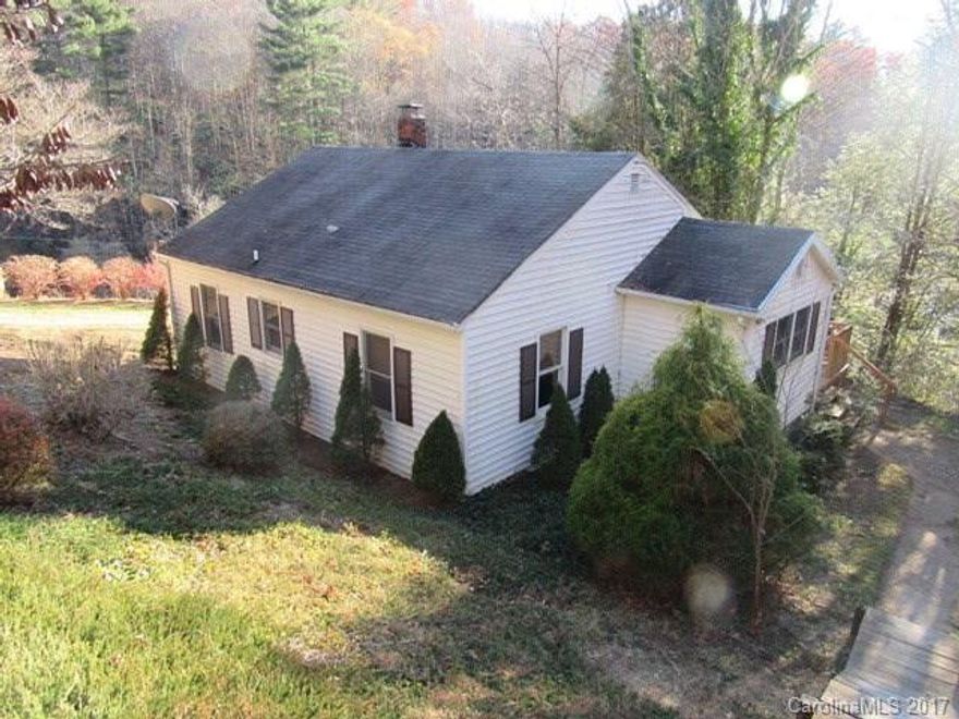 CONVENIENTLY LOCATED BETWEEN SPRUCE PINE & BAKERSVILLE.  Older farmhouse consisting of living room, combination kitchen/dining, utility room, 2 bedrooms & bath built in the 40's per tax card. Pull down steps in hallway to attic for storage. Covered front porch & open deck to enjoy mountain view & cool breeze.  Small shed for storage.  Health department was not able to locate septic layout.  All information is per tax records.  Buyer is advised to confirm all information.
