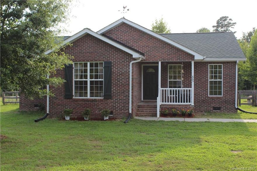 If you're looking for acreage and quality, here it is! Full-brick home located on almost 6 acres! Hardwoods throughout. Fenced back yard with deck, appx 1 acre is cleared around home and remainder of land is wooded for privacy. Rocking chair front porch. Updated kitchen with butcher block counter tops, farm house sink and marble backsplash! Bathrooms have updated sinks and mirrors. Walk-in laundry room. Absolutely adorable - you won't find a nicer home with acreage for such an amazing price!