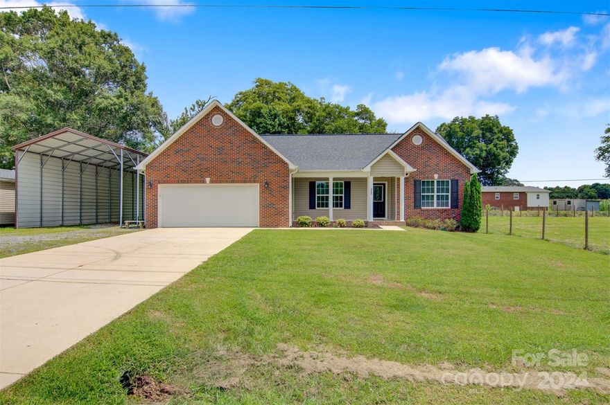 Must see, 3BR, 2BA brick & vinyl ranch style home situated on a 0.96 acre lot! There is a 2 car attached garage and a motor home/RV carport that has a 30 amp plug. Enter the home from the the covered front porch, to the great room with fireplace. There is a dining area off the kitchen. The kitchen features Granite countertops and stainless steel appliances. Split bedroom floorplan. Primary bedroom has en-suite bath with double sinks and walk-in closet. There is a large back deck overlooking the partially fenced yard with storage building. This property is within a half mile of a voluntary agriculture district.