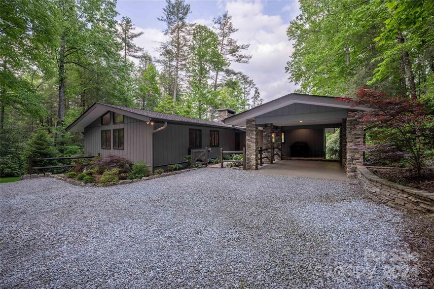 Introducing Happy Bear Cove, a newly renovated and move-in ready, one-level cozy lakefront cottage located in the prestigious Lake Toxaway Estates. This charming and idyllic property offers the perfect retreat for those seeking tranquility and natural beauty. Step inside to discover the inviting interior, featuring a stone wall entry and newly installed hardwood floors in a trio of Hickory, Oak, and Maple. The open living space boasts high ceilings and a stone fireplace, creating an airy and spacious atmosphere. Bountiful windows throughout the cottage allow natural light to fill the rooms, offering picturesque views of the lake and surrounding nature. Featuring 3 bedrooms and 2 bathrooms, this cottage provides ample space for comfort and relaxation. The gourmet kitchen is a culinary enthusiast's dream, equipped with high-end appliances and granite countertops. Adjacent to the kitchen, find a large walk-in pantry and laundry area, providing convenience and additional storage space.