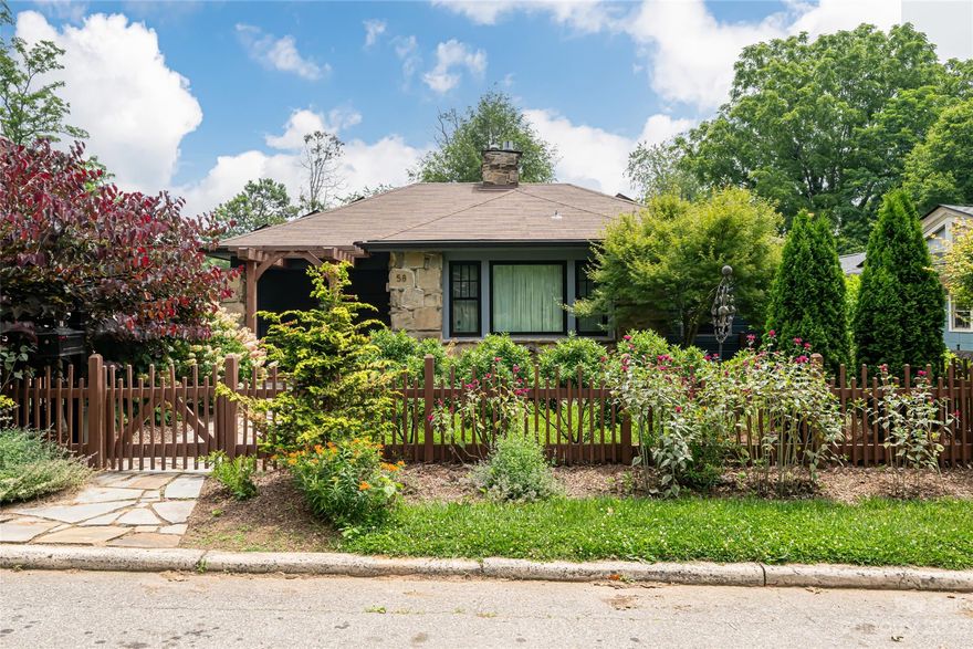 Introducing a remarkable real estate opportunity in West Asheville! This exquisite stone home is situated on a captivating site that was built on top of quartz. Solar panels complemented by Tesla batteries. A stunning screened in deck, patios, and an outdoor dining shelter ensure privacy and embrace the hot tub and surrounding native plants. Basement with separate entrance/bathroom that could be rented. Amazing separate home on-site (62 Trotter Pl), providing endless possibilities for guest accommodations, studio or additional rental income. The property is adorned with fruit trees and beautifully manicured gardens and 2 storage sheds. Property offers an easy walk to the pool at Malvern Hills Park. Elementary school is within walking distance. Don't miss out on the chance to own this exceptional West Asheville property, combining sustainability, natural beauty, and convenient access to amenities. Embrace a harmonious lifestyle in a lovely setting by securing this real estate gem today.