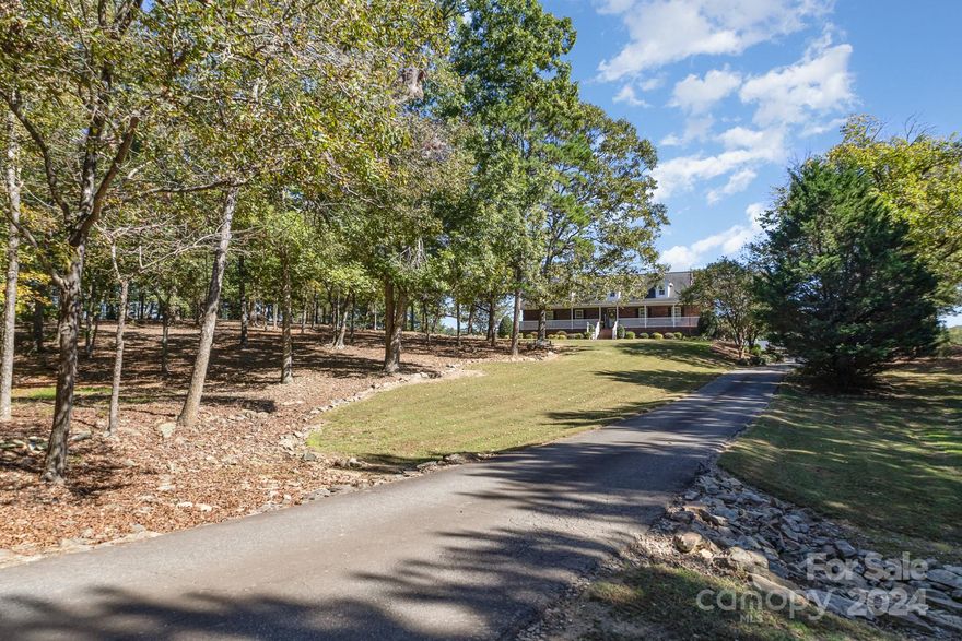 7 ACRES - Amazing all brick ranch home FULLY FURNISHED located in the desirable rural area of Locust with a private setting of approximately 7 areas of land (mix of open and wooded).  Opportunities for horses and/or a great location to build you own private pond.  This home has been meticulously updated and maintained.  Many features include all primary living area on main floor - 3 bedrooms, study used as a 4th bedroom, walk-in closets in all bedrooms, 3 full baths.  Finished bonus room and office on 2nd floor plus walk-in attic for plenty of storage.  Full basement with 2 garage doors and storm/storage room under front porch accessible from basement.  Beautifully landscaped with concrete parking area and asphalt driveway.  Separate 2 car detached carport and tractor shed.  Convenient to Charlotte, Concord, Harrisburg, Albemarle, Locust, Mount Pleasant.  A MUST SEE!! Broker owned