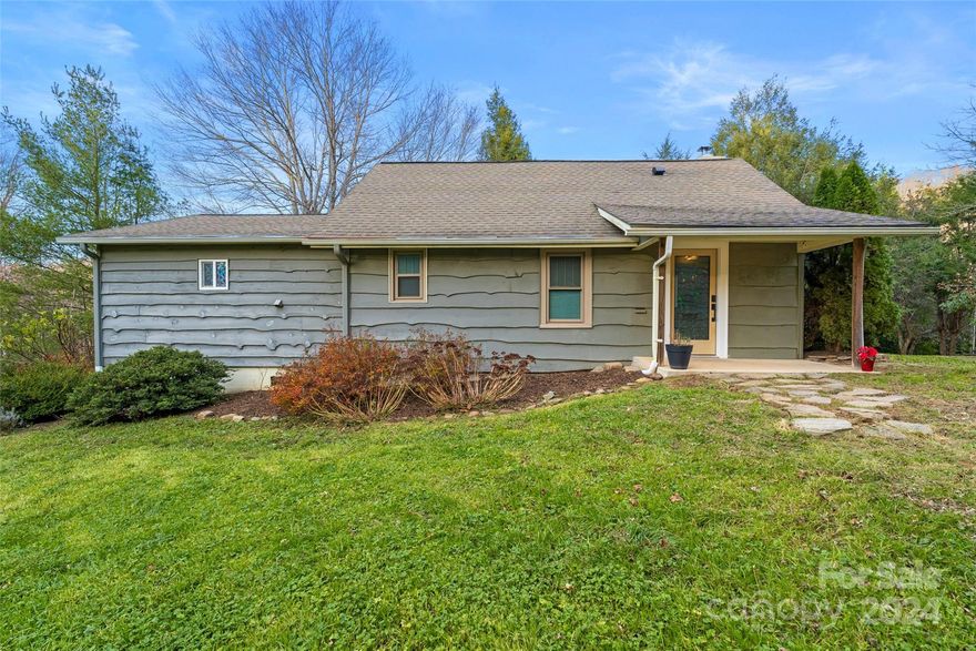 Here’s something to be grateful for: A delightful rustic homestead nestled on a sunny open parcel, cottagecore vibe, no HOA, no restrictions! Indulge in sustainable simplicity, create comfort, count your chickens or the stars or just rest easy on the private covered porch -sellers' thoughtful improvements since 2021 include windows, well pump, water heater & mainline, 200 amp panel, vinyl plank flooring, Osborn woodstove, fresh kitchen remodel, Bosch range/dishwasher & more. The fully fenced yard is ample enough for free range micro-farming, garden growing, maybe mowing (John Deere rider conveys) with mountain ridge winter views & leafy summer seclusion. Large outbuilding & well house offer storage for tools & projects. This easy access retreat is perfectly situated within minutes of Fairview's eclectic amenities & about 15 miles to Asheville making it an ideal forever home or seasonal/year round short term rental in the quiet beauty of the magical Blue Ridge.