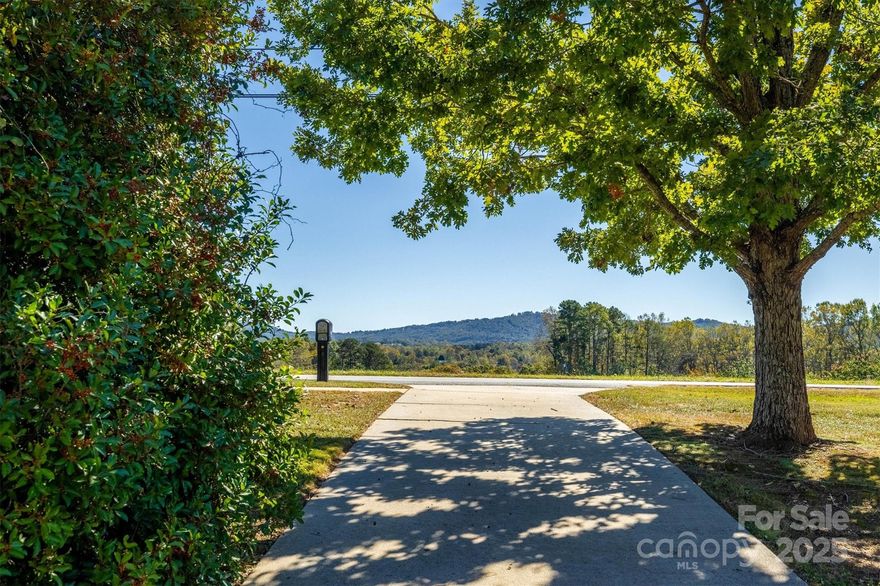 Enjoy sweeping mountain views right from your front porch or living room window—an ideal backdrop for peaceful living. Inside, you'll find a very nice layout with a cozy living room, plenty of natural light throughout and spacious bedrooms. This home offers beautiful hardwood flooring in the living room, hall and bedrooms. The large living room has a cozy fireplace and a huge window to enjoy those beautiful mountain views and lots of natural light. The kitchen and dining area are open and perfect for entertaining. 3 bedrooms on the main level are spacious with ample closet space in each room. The basement features a laundry area and functioning bathroom and still has lots of space for possible additional rooms, workshop or storage. The all-brick exterior and metal roof not only adds classic charm but also provides long-lasting, low-maintenance durability. Other exterior features are a private covered patio and nice large flat backyard that would be great for barbeques.