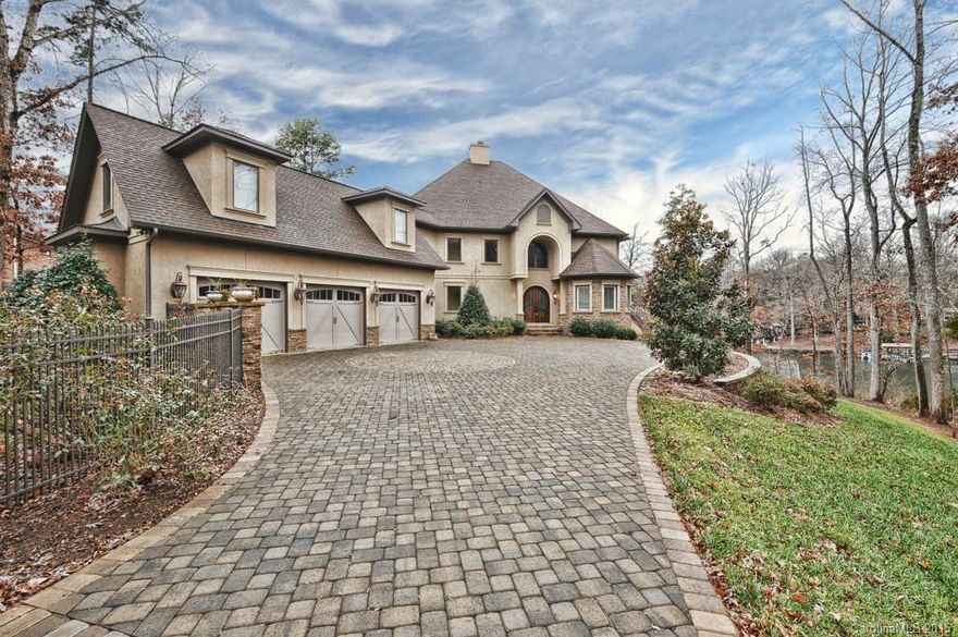 Exceptional gated custom built lakefront estate with captivating views. Enjoy lake living at its finest while being just a mile from restaurants and shopping centers. Entertain w/full outdoor kitchen, large patio, in-ground saltwater pool and jacuzzi, and access lake activities through the private pier and covered boat dock. Each spacious bedroom is appointed with a luxurious en-suite full bathroom. Gourmet kitchen w/Thermador Professional grade appliances.  Abundance of storage. 3 car garage!