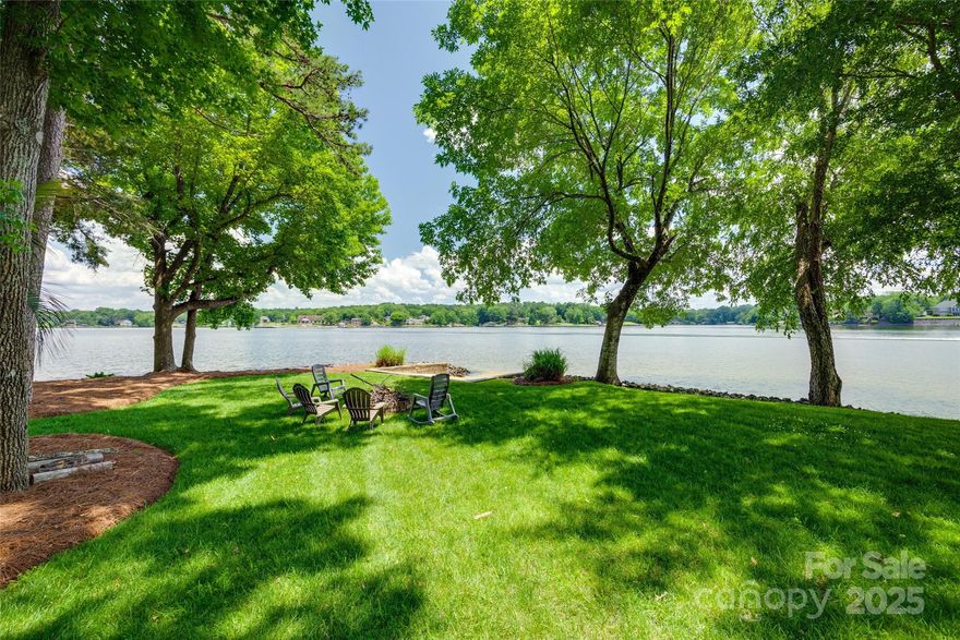 Beautifully designed spectacular Lake Wylie waterfront home on a private point with approx. 330 ft of shoreline along Little Allison Creek. Enjoy big water views, stunning sunsets, and a sandy beach with a fire pit. This beautifully designed home features low-maintenance Trex decking, a protected dock in a large bay, and a fully equipped outdoor kitchen with auto gas on the lower deck. A detached living quarters with private deck offers flexible space for guests or an office. The true man cave with outdoor sitting area is perfect for entertaining. Pristine landscaping with irrigation, low-voltage lighting, and a canopy of trees offers shade and serenity. Inside, enjoy main-level living with a cozy wood-burning fireplace and a spacious primary suite with dual closets and en-suite bath. Located in a highly desired, gated setting with no HOA. Thoughtfully designed for comfort and fun—don’t miss the feature sheet for full upgrades and details!