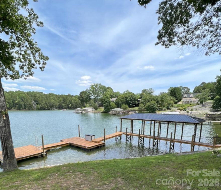 Price Improvement and ALL furnishings Included, Turn Keym Move in ready just in time to enjoy Memorial weekend in your new lake home.  Over 1 acre of Magnificent waterfront unrestricted land (NO HOA) with approx 217' of stabalized shoreline, a 40' covered fixed boatslip and additional floating dock. Build your future home while you live in the 2024 build secondary home with 2 bedrooms a dedicated office or you could use this as a 3rd bedroom and 2 car garage. No expense was spared during the construction. The complete Kitchen Aid appliance package, Additional holiday dishes can be stored in the hidden cabinets in front of the bar stools, Tankless propane water heater, Sono's sound system indoor and out, complete wifi home and wifi at the dock, Lake fed irrigaion pump installed, Power at the dock for a future lift, Smart home wiring, Generator transfer switch installed, 30amp Electric car charger in the garage and so much more. You never have to worry if you have enought dock space for your friends and family. Enjoy every night sitting on your covered porch or on the covered dock with a seating area. Fall firepit nights with the peace and tranquility you have been searching for. Bring your own builder or have a chat with the builder that constructed this wonderful open floor plan contemporary home. Did we mention there is a former block boathouse that could be converted into a Jimmy Buffet style waterfront retreat. Long range waterfront views from the primary bedroom, great room, kitchen and home office. You can enjoy Lake Norman year round with deep water even when Duke energy brings the lake down during the winter months. You can realize what you have vizualized in your new construction home or just enjoy the current home and the lay of the level land. We've included a sample rendering of the primary home which was going to be constructed with the garage and front door on the street side with a wall of sliding glass doors for the bunk room, bathroom and hall. Basically flipping the garage level from back to front. To access the home office or could be used as a 3rd bedroom, enter throught the garage. Magnificent Waterfront views from the sliding glass door. Maximum building footprint is 50 x 60