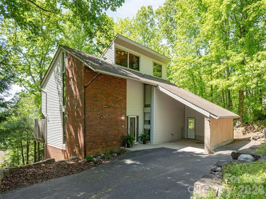 You'll start to relax on your way home as you drive past a pasture with cattle grazing and a creek flowing as you make your way up Concord Mountain to the nestled away subdivision of Sequoyah Hills. A custom built home for full time living, a second home, or a short term vacation rental. Thoughtful three level floor plan where everyone has privacy and their own full bath, while still enjoying shared gathering spaces. Hickory wood floors, solid wood doors, massive stone wood burning fireplace to the ceiling, high vault ceilings ,high windows and a nice retro feel. The wrap around deck with woodsy privacy and the covered flagstone patio are great gathering places. Balconies off the upper bedrooms are a special treat with Mt Pisgah view! Unique features not found in most subdivisions, loft area accessed by ladder, custom bookcases in the family room, a full bathroom for each bedroom, dining room easily could be an office by closing the wooden pocket doors, those high ceilings and that stone fireplace, in a low restricted subdivision with low dues, in TC Roberson school district. It has that vacation feel and you can feel it everyday.